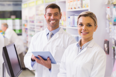 two pharmacists smiling on the pharmacy