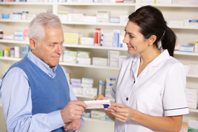 old man receiving tablets from the pharmacy