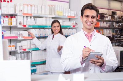 two pharmacists smiling and checking the tablets